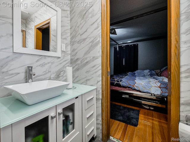 13973 Dixie, Redford, MI 48239 - bathroom featuring vanity, tile walls, and wood finished floors