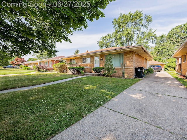 13973 Dixie, Redford, MI 48239 - single story home with brick siding, a front yard, and a chimney