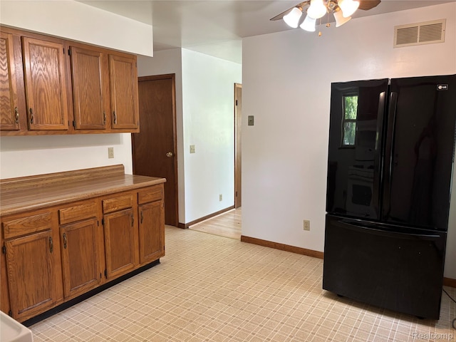 1096 Bayfield St, Lake Orion, MI 48362 - kitchen featuring freestanding refrigerator, a ceiling fan, brown cabinetry, and light countertops