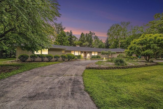 1205 Sassafras Ln, Niles, MI 49120 - ranch-style house featuring driveway, a lawn, a chimney, and brick siding