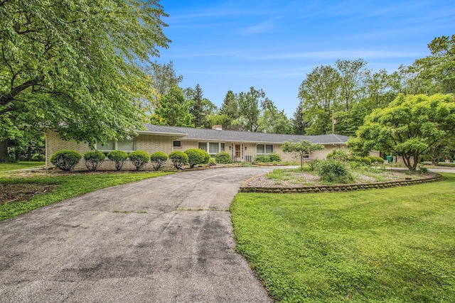 1205 Sassafras Ln, Niles, MI 49120 - ranch-style house featuring driveway, a front lawn, a chimney, and brick siding