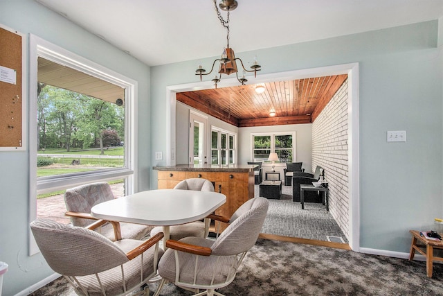 1205 Sassafras Ln, Niles, MI 49120 - carpeted dining area with wooden ceiling, a chandelier, and baseboards