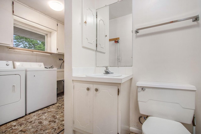 1205 Sassafras Ln, Niles, MI 49120 - half bathroom with washer and clothes dryer, vanity, toilet, and stone finish flooring