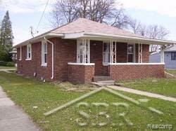 2500 Salt St, Saginaw, MI 48602 - view of front of property featuring a front lawn and brick siding