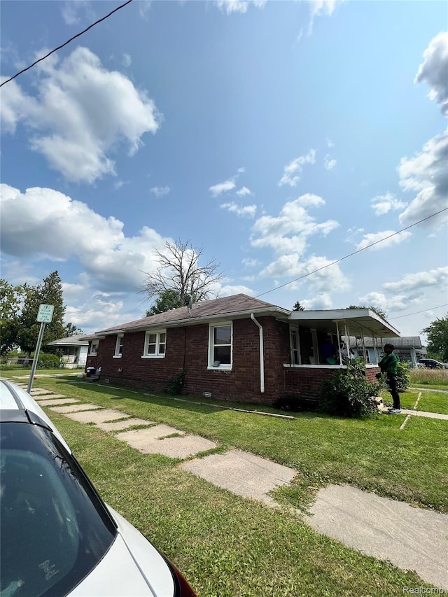 2500 Salt St, Saginaw, MI 48602 - view of home's exterior with brick siding and a lawn