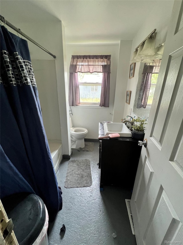 2500 Salt St, Saginaw, MI 48602 - bathroom with vanity, toilet, healthy amount of natural light, and shower / tub combo with curtain