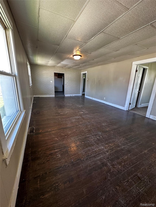 2500 Salt St, Saginaw, MI 48602 - spare room featuring baseboards, a drop ceiling, and wood-type flooring
