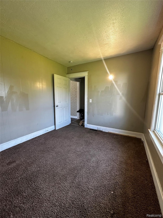 2500 Salt St, Saginaw, MI 48602 - spare room with a textured ceiling, carpet floors, and baseboards
