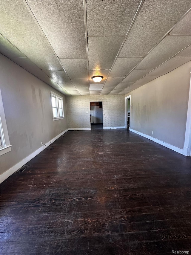 2500 Salt St, Saginaw, MI 48602 - empty room featuring hardwood / wood-style flooring, a paneled ceiling, and baseboards