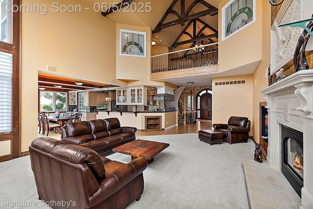 10611 Lighthouse Pt, South Lyon, MI 48178 - living area with high vaulted ceiling, a glass covered fireplace, carpet, and baseboards