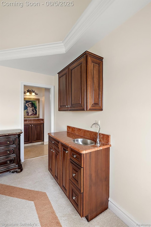 10611 Lighthouse Pt, South Lyon, MI 48178 - kitchen with a sink, crown molding, light colored carpet, baseboards, and dark brown cabinetry