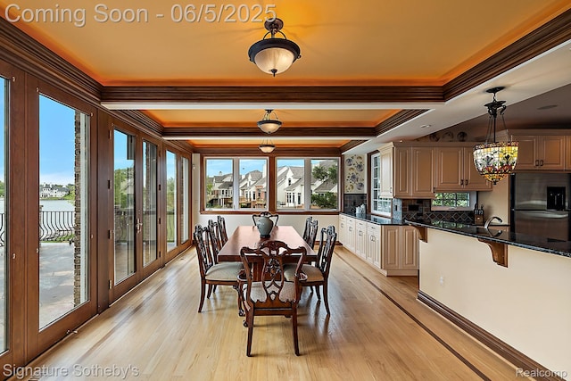 10611 Lighthouse Pt, South Lyon, MI 48178 - dining room featuring ornamental molding, light wood finished floors, and a chandelier