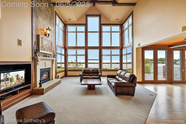 10611 Lighthouse Pt, South Lyon, MI 48178 - living area with high vaulted ceiling, a fireplace, and baseboards