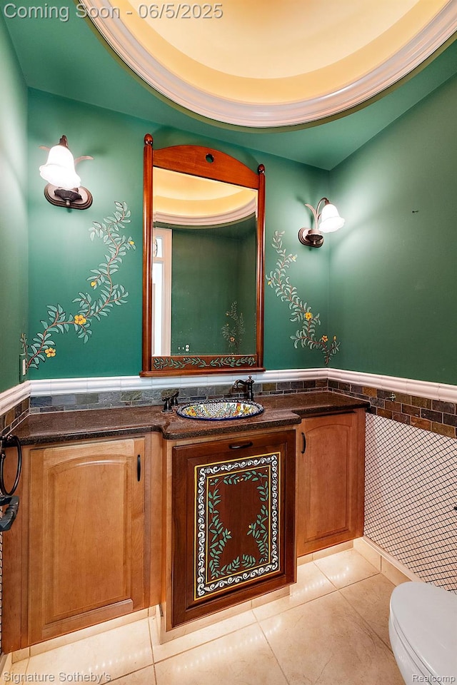 10611 Lighthouse Pt, South Lyon, MI 48178 - bathroom with a wainscoted wall, vanity, tile walls, toilet, and tile patterned floors
