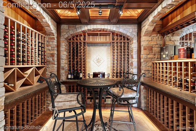 10611 Lighthouse Pt, South Lyon, MI 48178 - wine cellar featuring wooden ceiling with exposed beams, tile patterned flooring, and brick wall