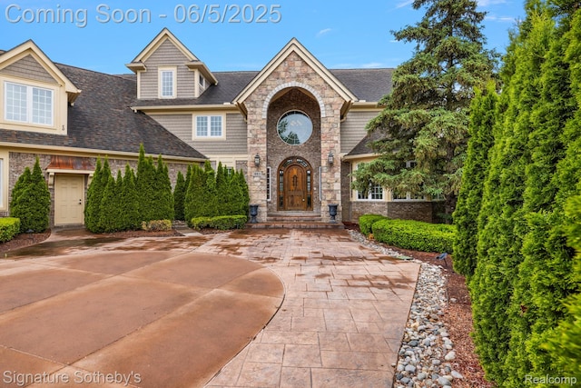10611 Lighthouse Pt, South Lyon, MI 48178 - view of front of property with roof with shingles, stone siding, and brick siding