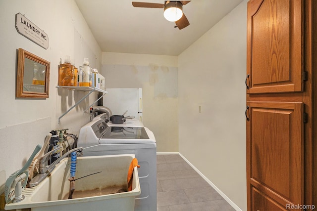 7184 Grand River Rd, Bancroft, MI 48414 - laundry area with washing machine and clothes dryer, light tile patterned floors, ceiling fan, baseboards, and cabinet space