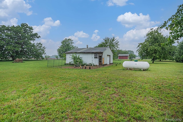 7184 Grand River Rd, Bancroft, MI 48414 - view of grassy yard featuring a detached garage and an outdoor structure