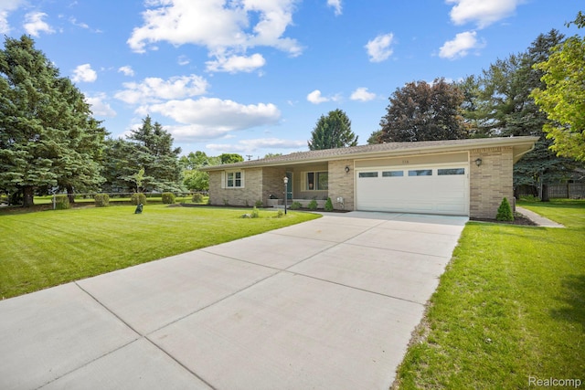 116 Surrey Rd, Saint Louis, MI 48880 - ranch-style home with an attached garage, concrete driveway, a front lawn, and brick siding