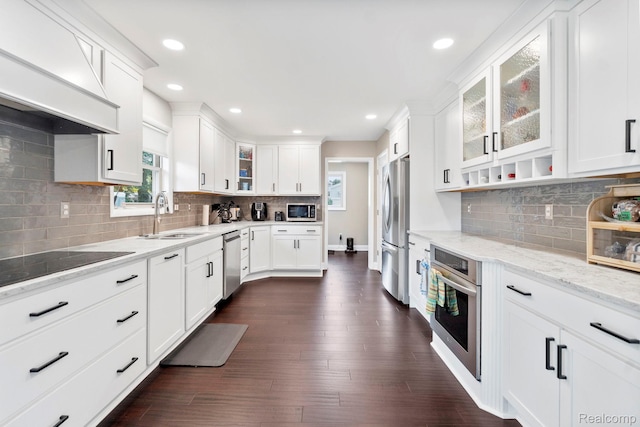 116 Surrey Rd, Saint Louis, MI 48880 - kitchen with stainless steel appliances, a sink, custom exhaust hood, white cabinetry, and decorative backsplash