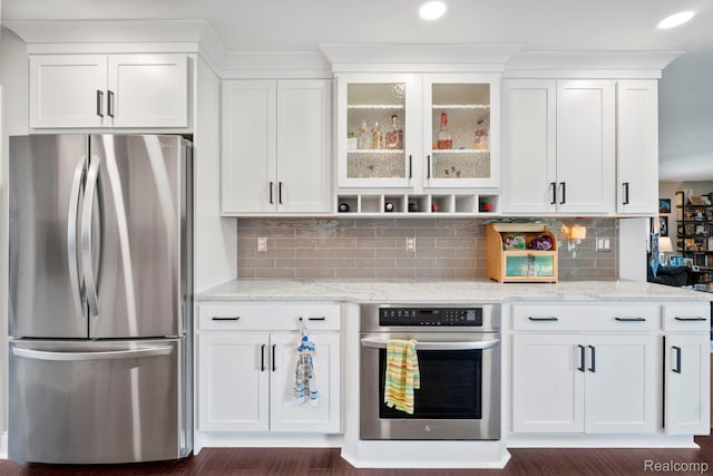 116 Surrey Rd, Saint Louis, MI 48880 - kitchen featuring appliances with stainless steel finishes, white cabinets, light stone counters, glass insert cabinets, and recessed lighting