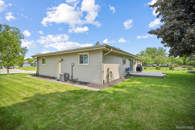 116 Surrey Rd, Saint Louis, MI 48880 - rear view of property with a wooden deck, central AC, and a lawn