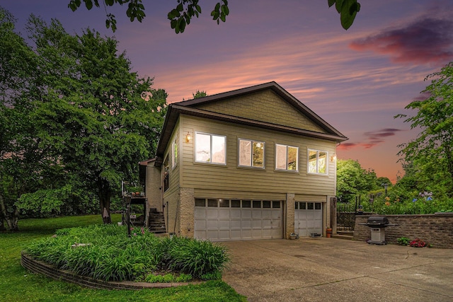 22649 N Dixboro Rd, South Lyon, MI 48178 - view of front of property with stairs, concrete driveway, a garage, and brick siding