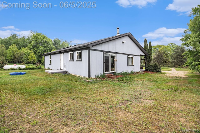 3275 Levalley Rd, Columbiaville, MI 48421 - rear view of property with entry steps and a yard