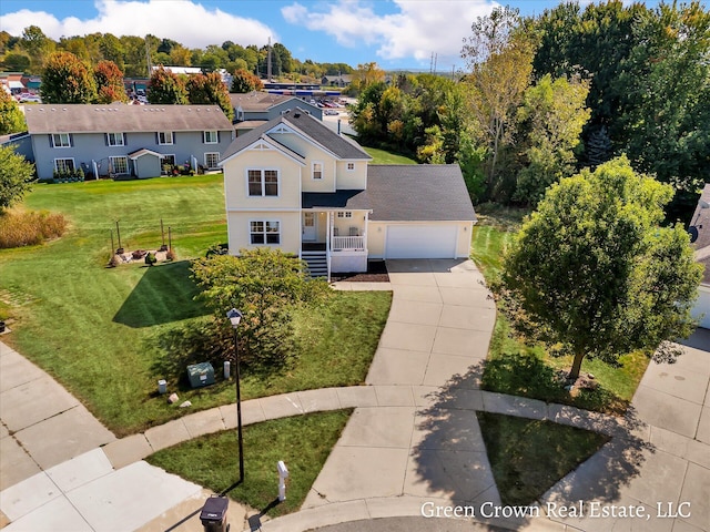 4052 Quest Ct SW, Wyoming, MI 49418 - view of front of house featuring concrete driveway, covered porch, a front yard, a garage, and a shingled roof