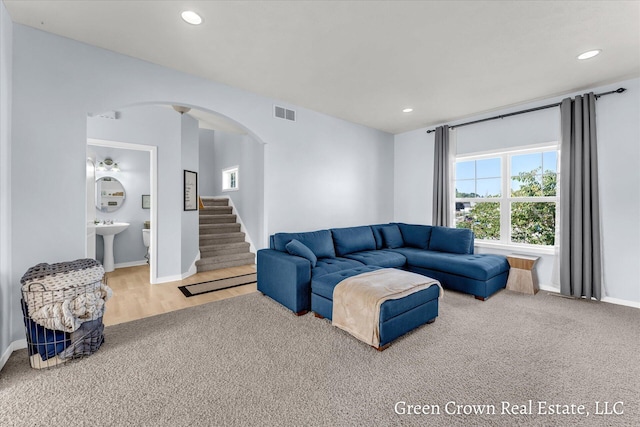 4052 Quest Ct SW, Wyoming, MI 49418 - living area with arched walkways, baseboards, stairs, recessed lighting, and carpet floors