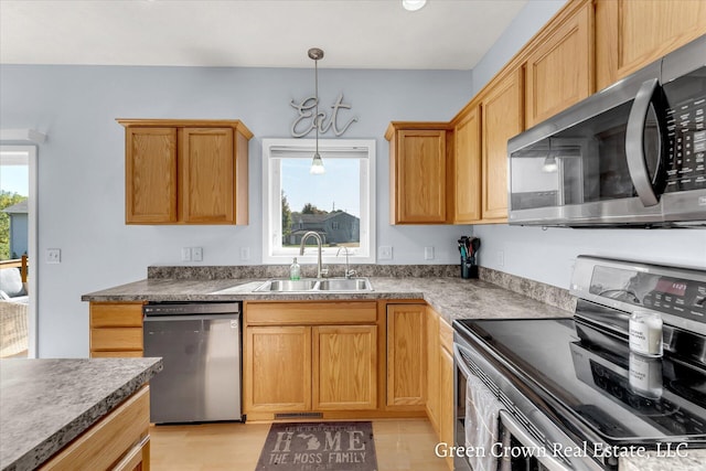 4052 Quest Ct SW, Wyoming, MI 49418 - kitchen with appliances with stainless steel finishes, a sink, and decorative light fixtures