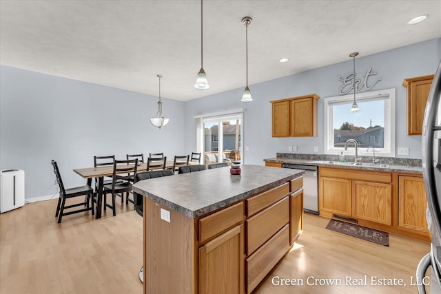 4052 Quest Ct SW, Wyoming, MI 49418 - kitchen featuring a sink, stainless steel dishwasher, light wood-style flooring, a center island, and hanging light fixtures