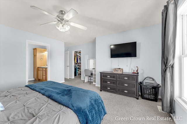 4052 Quest Ct SW, Wyoming, MI 49418 - bedroom featuring a spacious closet, carpet floors, ceiling fan, ensuite bathroom, and baseboards