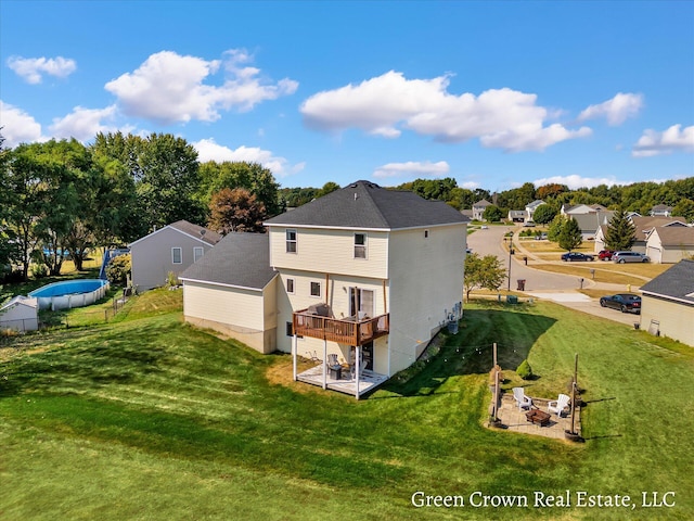 4052 Quest Ct SW, Wyoming, MI 49418 - back of property with a wooden deck, a residential view, and a yard