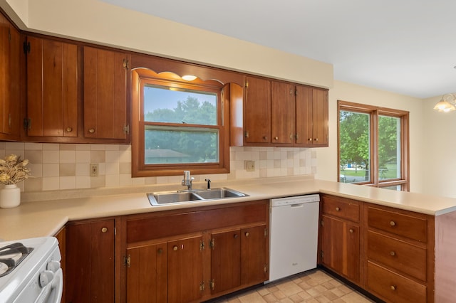 4564 Sparrow Ave, Kalamazoo, MI 49004 - kitchen featuring dishwasher, a sink, light countertops, and backsplash