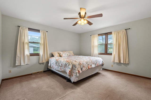 4564 Sparrow Ave, Kalamazoo, MI 49004 - carpeted bedroom with multiple windows, baseboards, and a ceiling fan