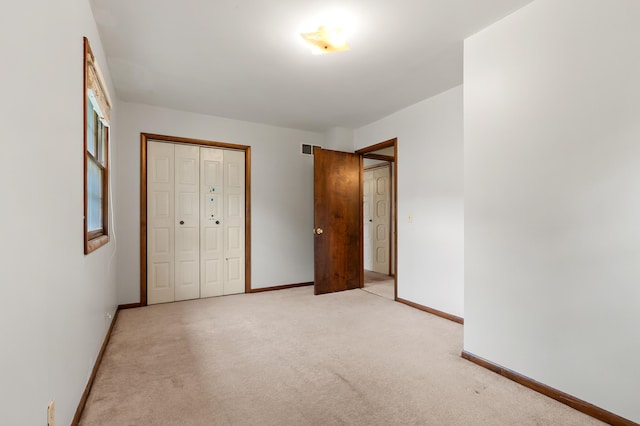 4564 Sparrow Ave, Kalamazoo, MI 49004 - unfurnished bedroom featuring baseboards, light colored carpet, and a closet