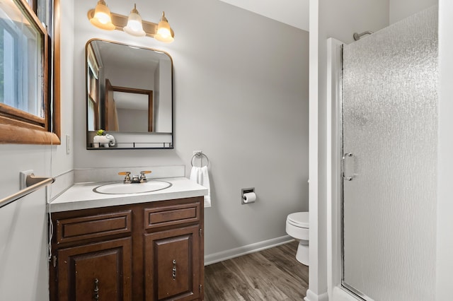 4564 Sparrow Ave, Kalamazoo, MI 49004 - full bathroom featuring vanity, toilet, a stall shower, wood finished floors, and baseboards