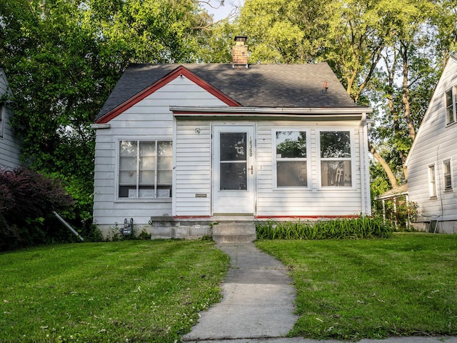 18350 Codding St, Detroit, MI 48219 - bungalow with roof with shingles, a front yard, and a chimney