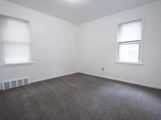 18350 Codding St, Detroit, MI 48219 - spare room featuring dark carpet and baseboards