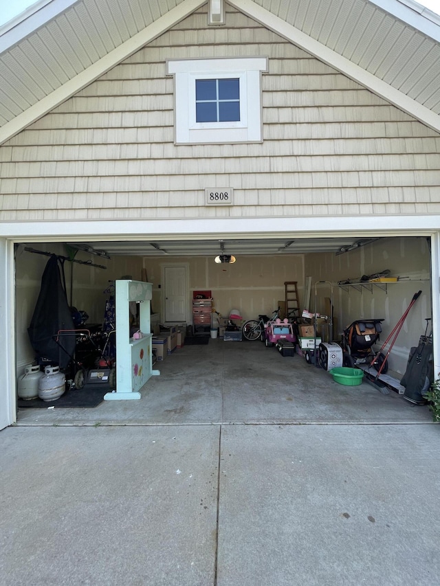 8808 Geiser Grv, Richland, MI 49083 - garage with concrete driveway and a garage door opener