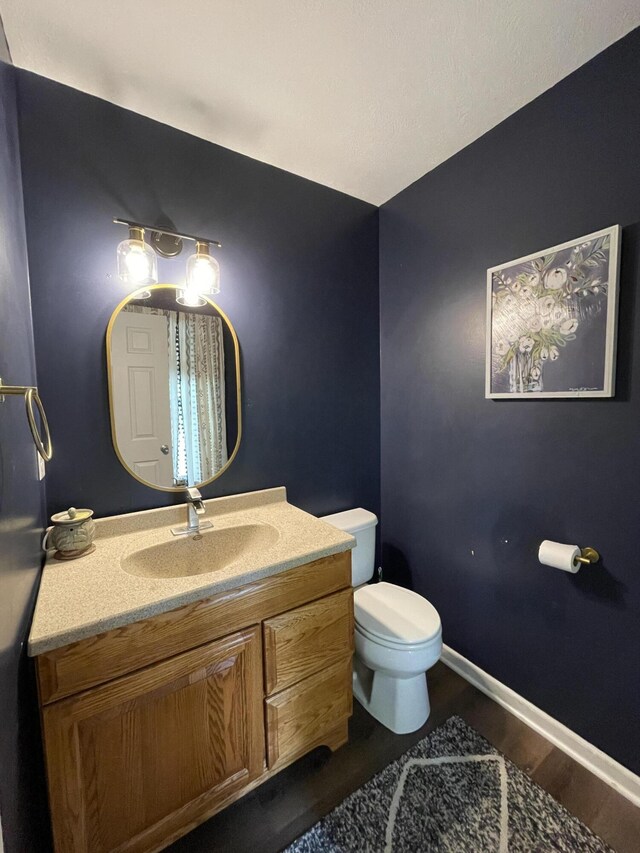 8808 Geiser Grv, Richland, MI 49083 - bathroom featuring toilet, vanity, wood finished floors, and baseboards