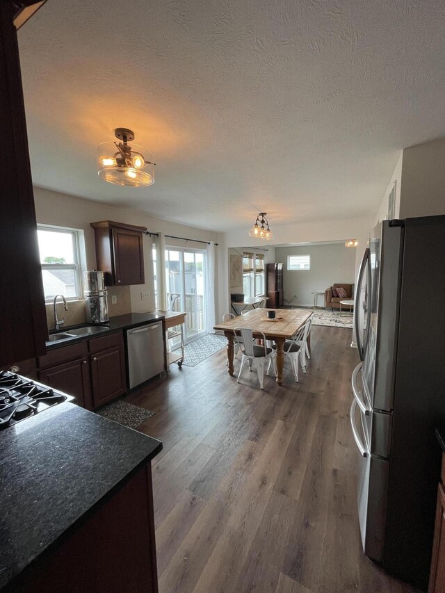 8808 Geiser Grv, Richland, MI 49083 - kitchen with appliances with stainless steel finishes, dark countertops, dark wood finished floors, a sink, and plenty of natural light