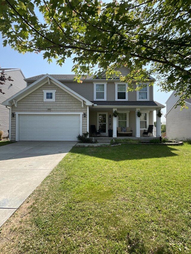 8808 Geiser Grv, Richland, MI 49083 - view of front of home featuring covered porch, concrete driveway, an attached garage, and a front lawn