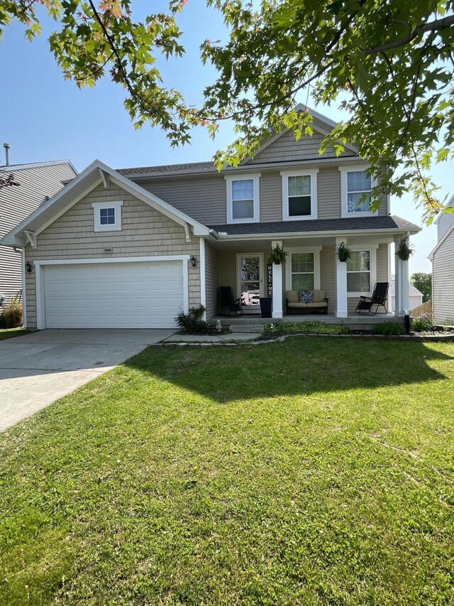 8808 Geiser Grv, Richland, MI 49083 - view of front facade with an attached garage, driveway, a front lawn, and covered porch