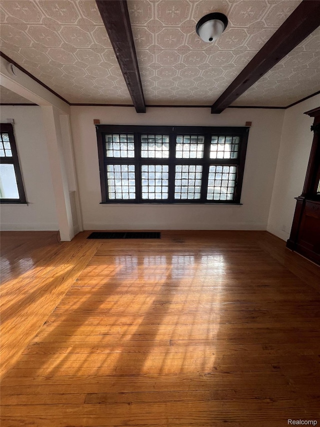 3137 S Washington Ave, Saginaw, MI 48601 - spare room featuring an ornate ceiling, wood-type flooring, beamed ceiling, and baseboards