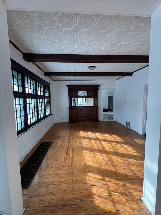 3137 S Washington Ave, Saginaw, MI 48601 - corridor with beam ceiling, hardwood / wood-style floors, and baseboards