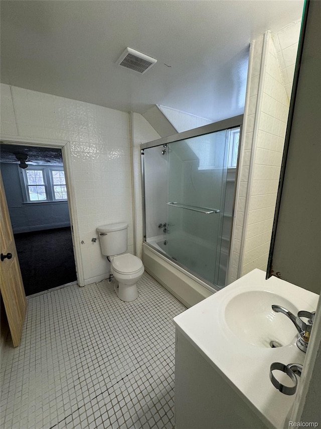 3137 S Washington Ave, Saginaw, MI 48601 - bathroom featuring toilet, combined bath / shower with glass door, vanity, and tile patterned floors