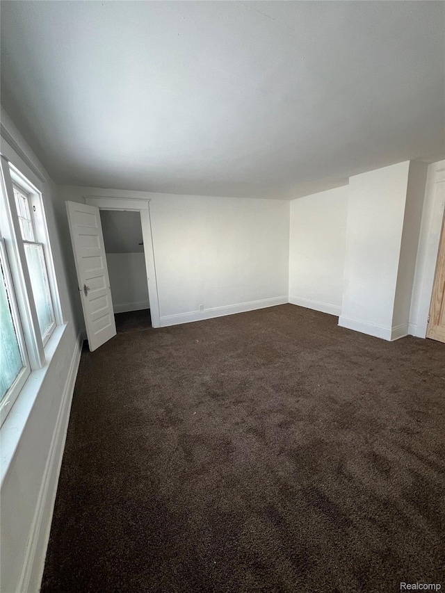 3137 S Washington Ave, Saginaw, MI 48601 - unfurnished bedroom featuring dark colored carpet and baseboards