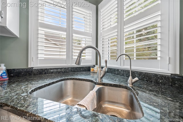 2336 Swans Cv Unit 7, Fenton, MI 48430 - kitchen view of a sink and dark stone counters
